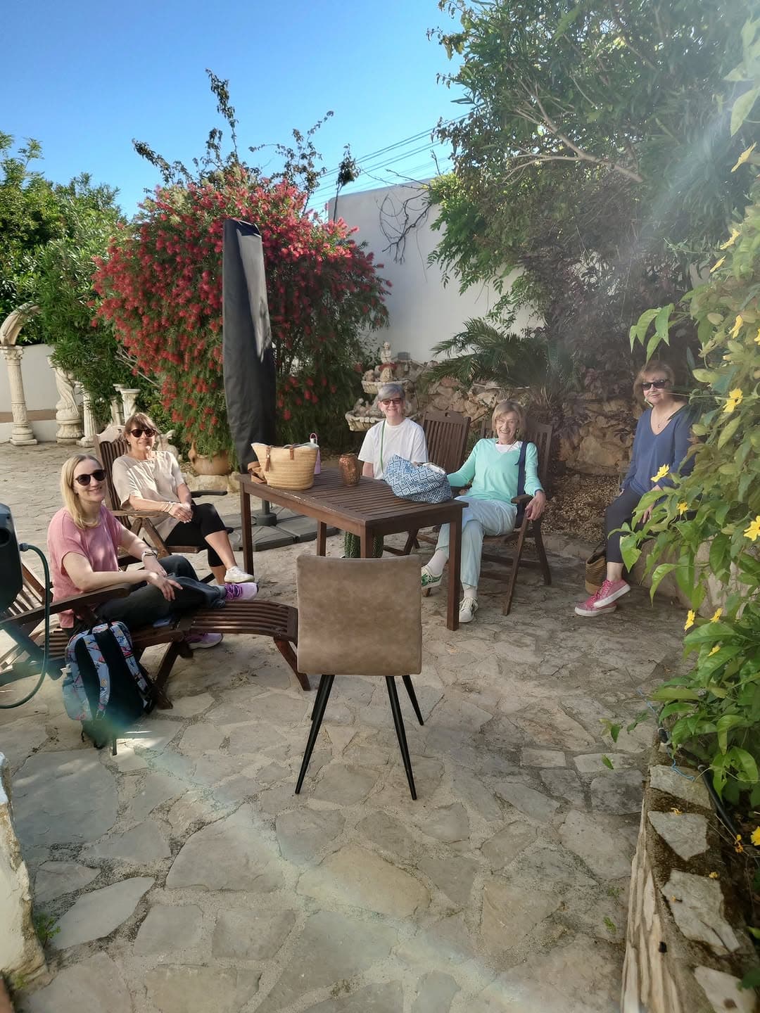 Retreat clients smiling together in a Spanish courtyard